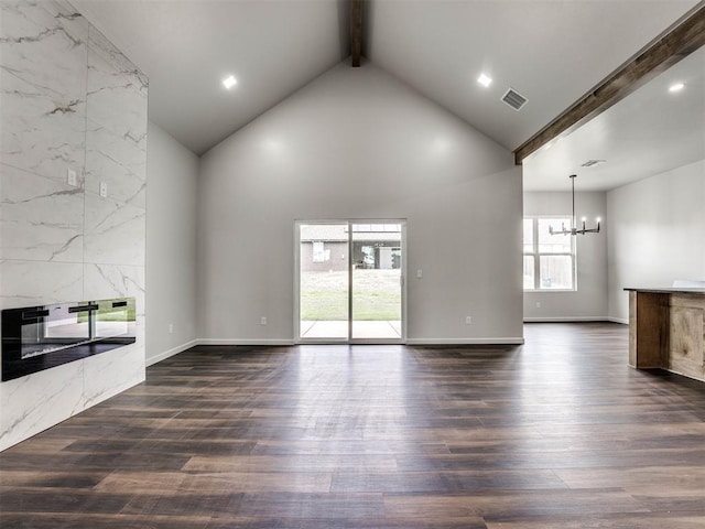 unfurnished living room with a premium fireplace, high vaulted ceiling, dark hardwood / wood-style flooring, a notable chandelier, and beam ceiling