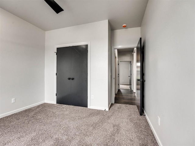 unfurnished bedroom featuring ceiling fan, carpet floors, and a closet