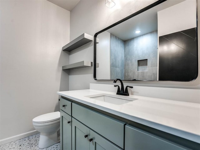 bathroom featuring toilet and vanity