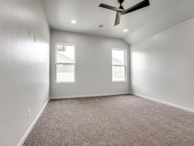 unfurnished room with carpet flooring, ceiling fan, and vaulted ceiling