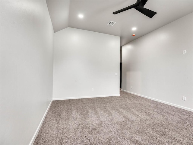 spare room featuring lofted ceiling, ceiling fan, and carpet