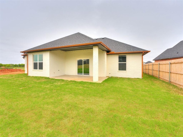 rear view of house with a lawn and a patio area