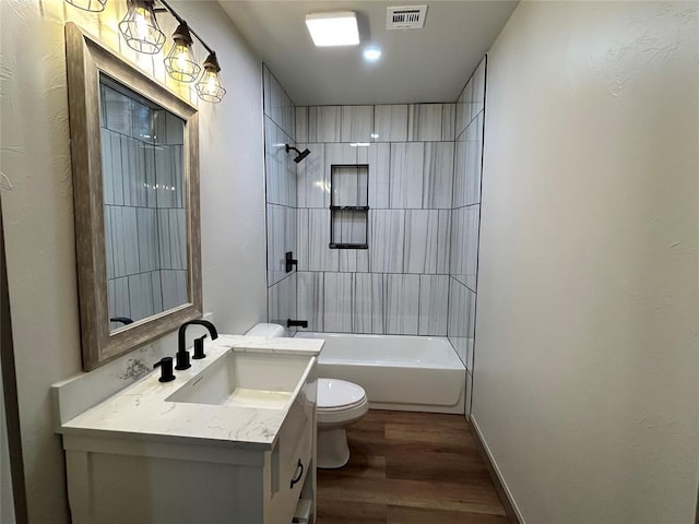 full bathroom with toilet, hardwood / wood-style flooring, shower / washtub combination, and vanity