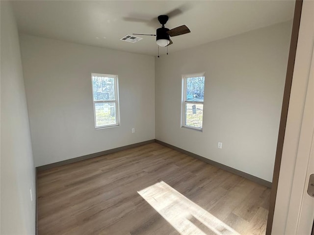 unfurnished room featuring ceiling fan and light wood-type flooring