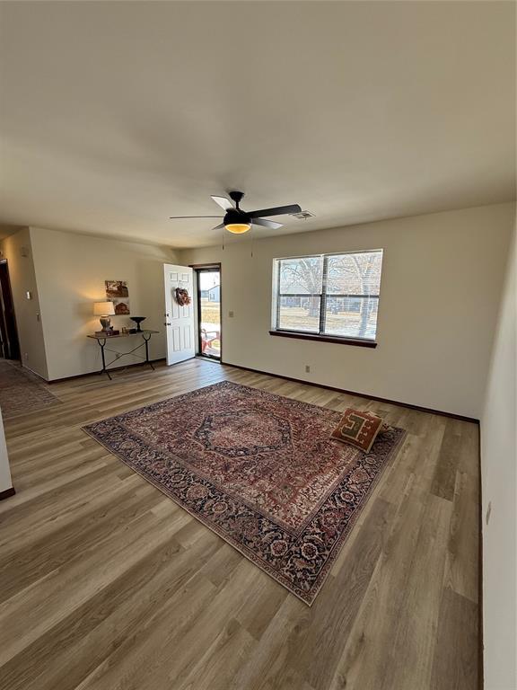 living area with ceiling fan and wood finished floors