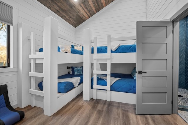 bedroom featuring vaulted ceiling, dark wood-type flooring, and wood ceiling