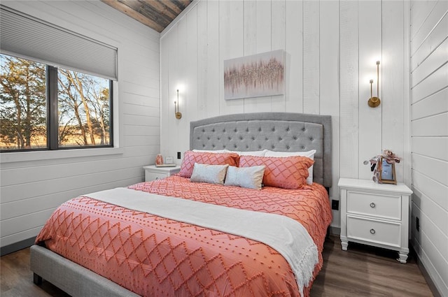 bedroom featuring wood ceiling, dark hardwood / wood-style floors, and wooden walls