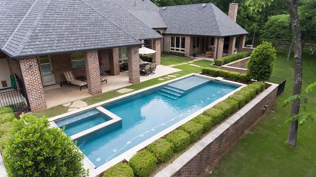 view of pool with a lawn and a patio area