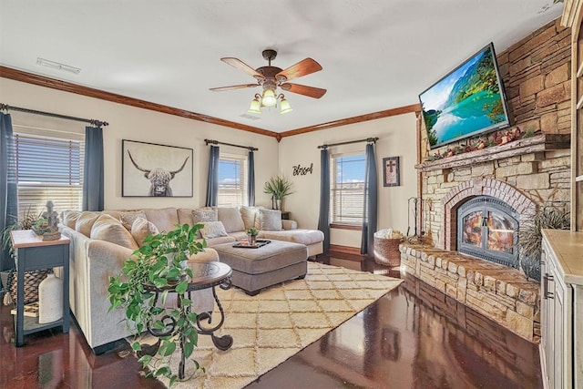 living room featuring crown molding, a large fireplace, and ceiling fan