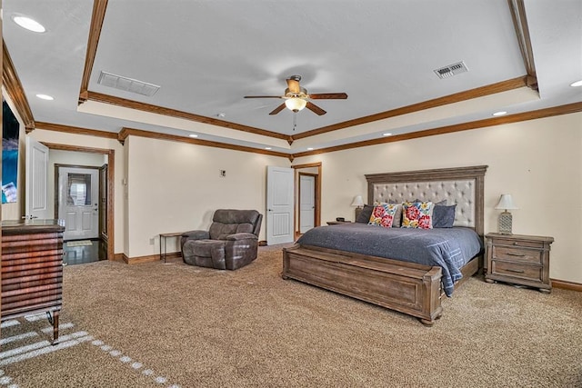 carpeted bedroom with a raised ceiling, ornamental molding, and ceiling fan