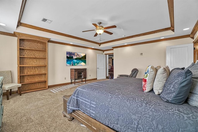 carpeted bedroom with crown molding, ceiling fan, and a tray ceiling