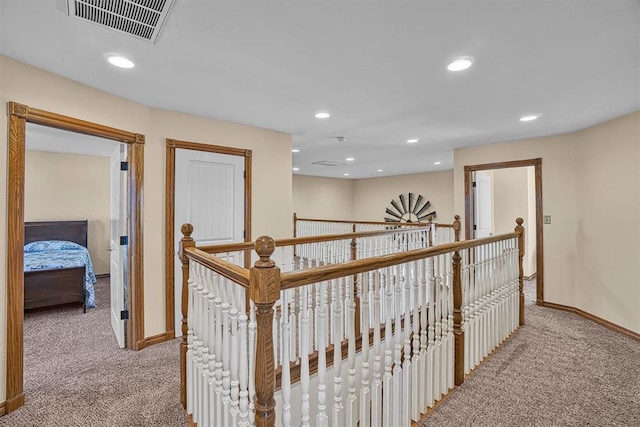 hallway with light colored carpet