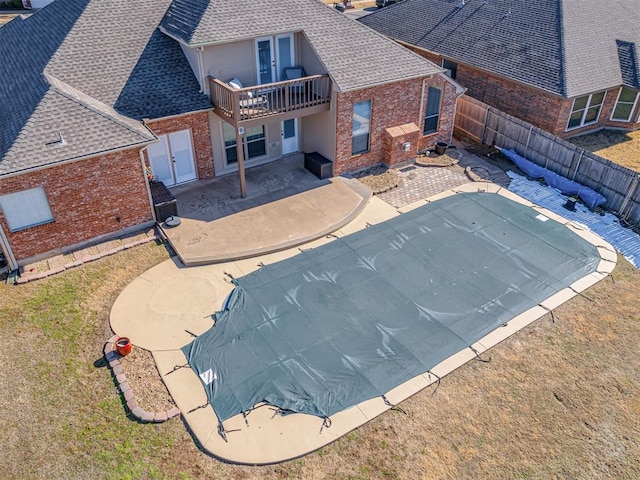 view of pool with a lawn and a patio