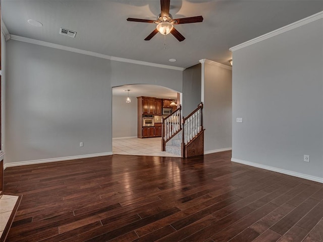 unfurnished living room featuring ceiling fan, dark hardwood / wood-style floors, and crown molding