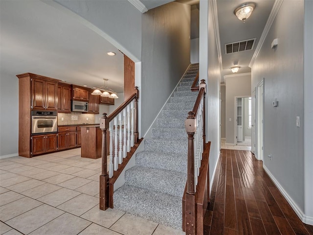 staircase with crown molding