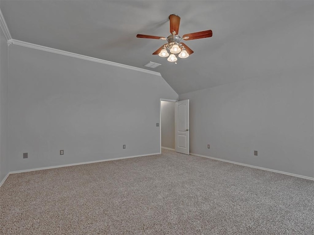 carpeted empty room featuring ceiling fan, ornamental molding, and lofted ceiling