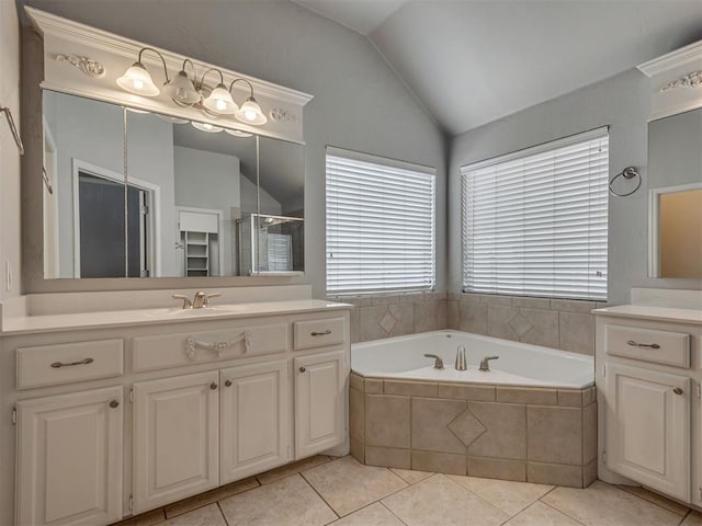 bathroom featuring tile patterned floors, vanity, independent shower and bath, and vaulted ceiling