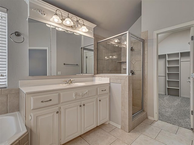 bathroom with tile patterned floors, vanity, and separate shower and tub