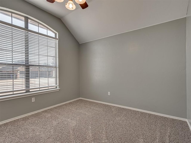 unfurnished room featuring ceiling fan, vaulted ceiling, and carpet floors