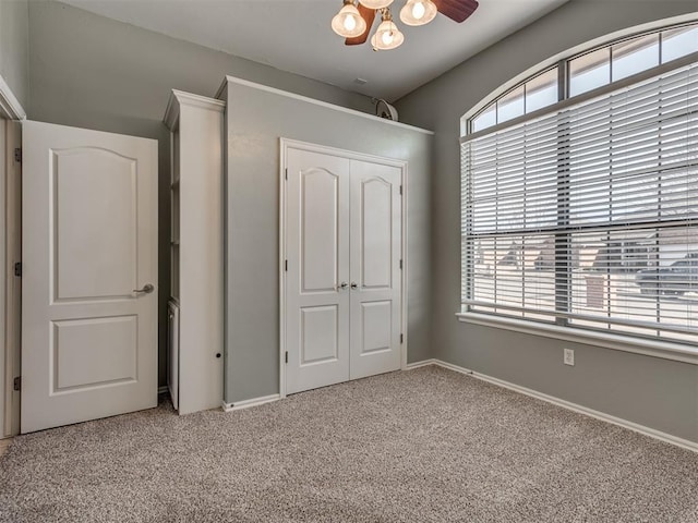 unfurnished bedroom with light carpet and a closet