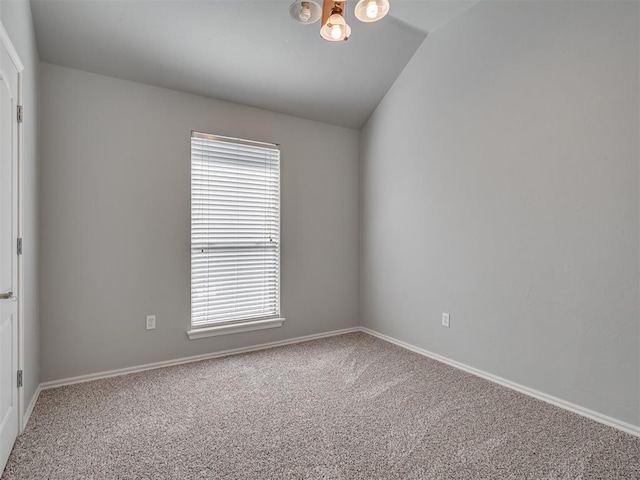 carpeted spare room with vaulted ceiling and plenty of natural light