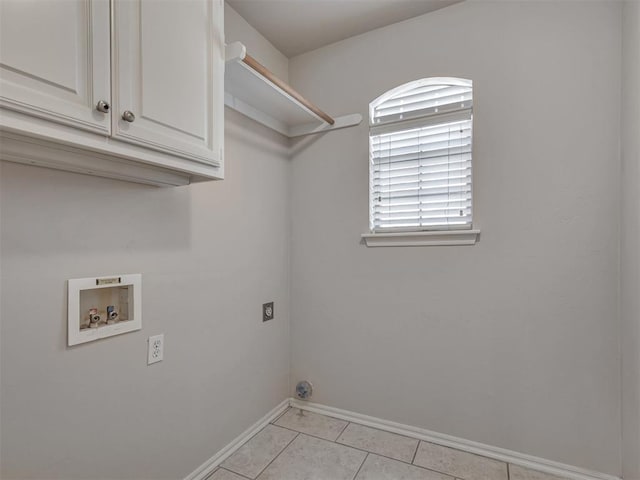 clothes washing area featuring light tile patterned flooring, cabinets, hookup for a washing machine, and hookup for an electric dryer