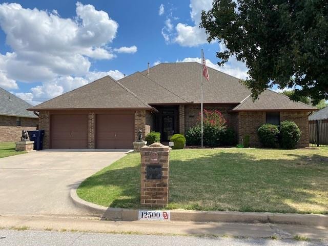 view of front of property with a front yard and a garage