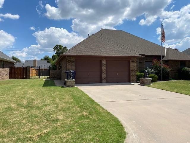 view of front of property with a front lawn and a garage