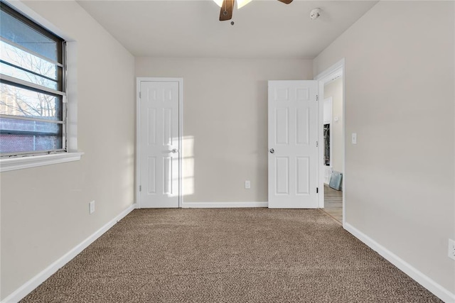 spare room featuring ceiling fan and carpet flooring