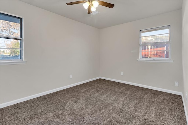 carpeted spare room featuring ceiling fan