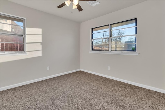 unfurnished room with ceiling fan, carpet, and a wealth of natural light