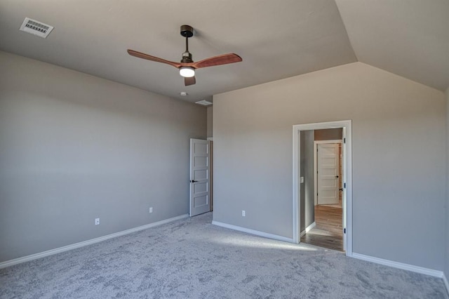 unfurnished bedroom with ceiling fan, light colored carpet, and vaulted ceiling