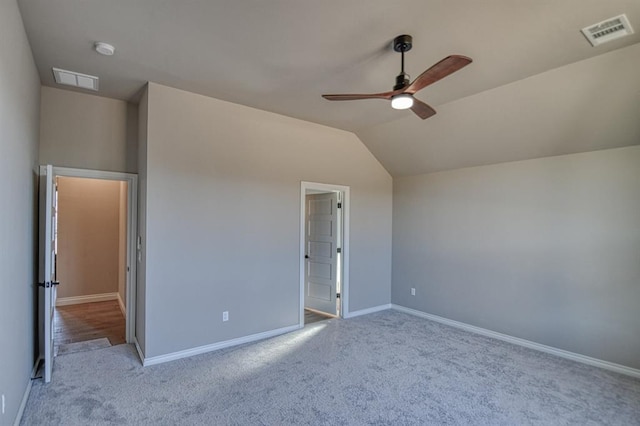 unfurnished bedroom with vaulted ceiling, ceiling fan, and light colored carpet