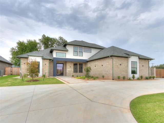 view of front facade with central AC and a front lawn