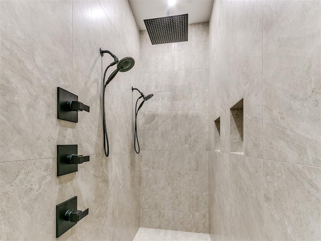 interior details featuring a tile shower