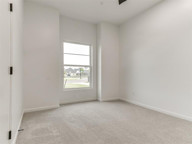 spare room with light colored carpet