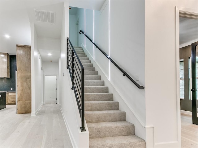 staircase featuring hardwood / wood-style flooring