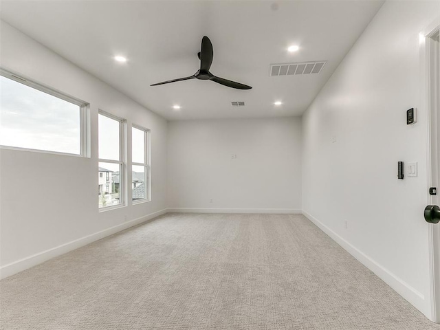 carpeted spare room with ceiling fan