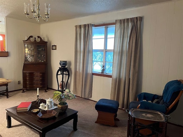 living room with carpet floors, a textured ceiling, a notable chandelier, and wooden walls