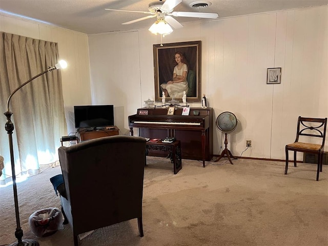 sitting room featuring light carpet and ceiling fan