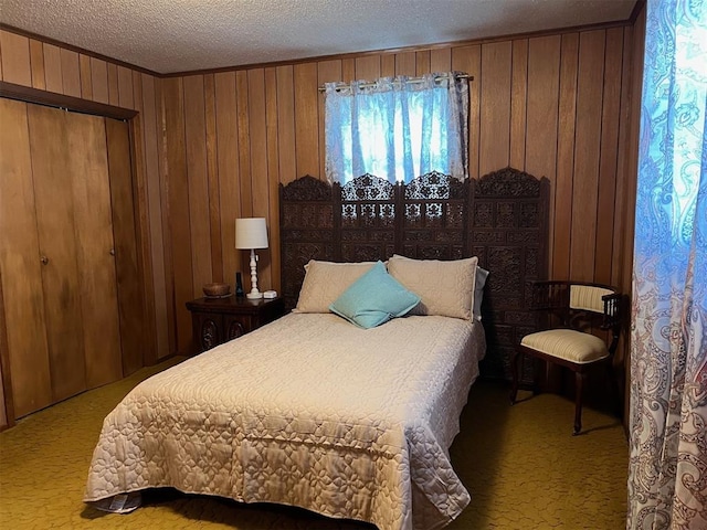 carpeted bedroom featuring a closet, wood walls, and a textured ceiling