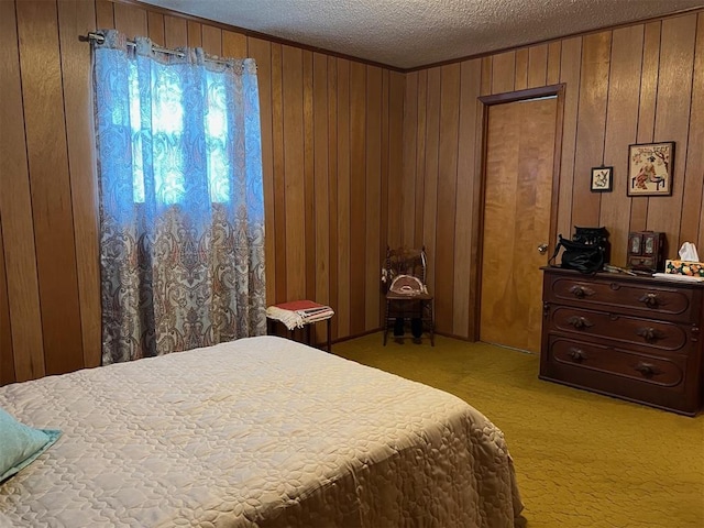 carpeted bedroom featuring wood walls and a textured ceiling