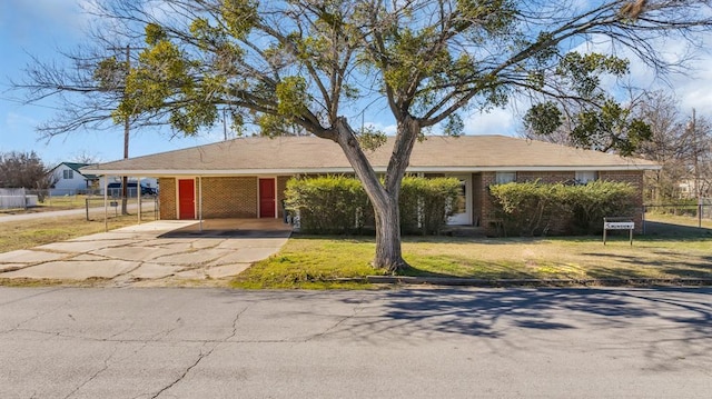 ranch-style house with a front lawn and a carport