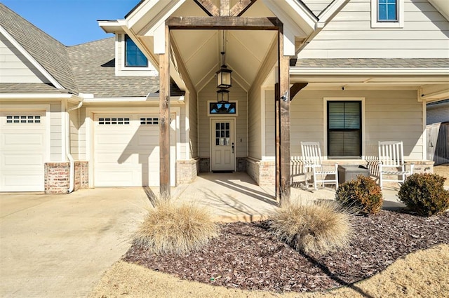 doorway to property with a garage and a porch