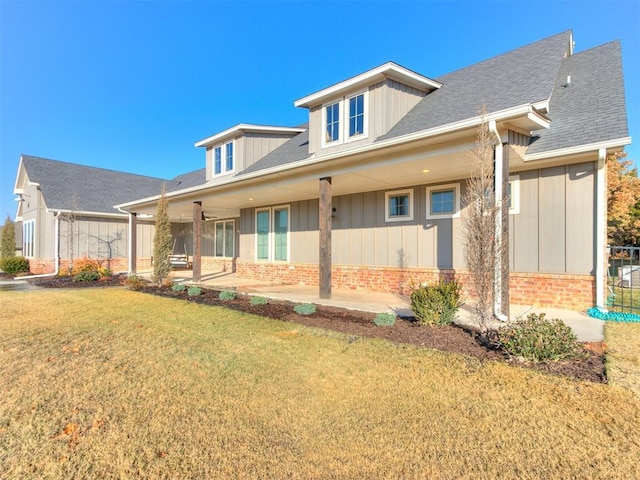 view of front of home with a patio area and a front lawn