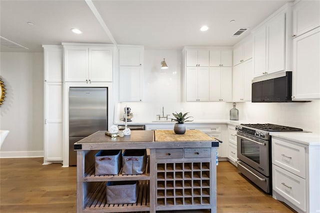 kitchen with stainless steel appliances and white cabinets