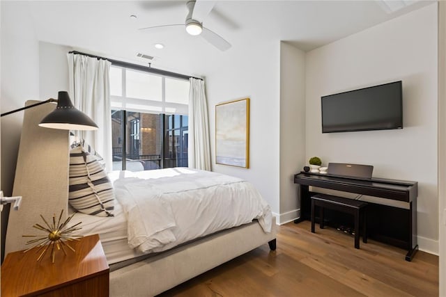 bedroom featuring ceiling fan, hardwood / wood-style floors, and access to exterior