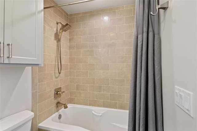 bathroom featuring shower / bath combination with curtain and toilet