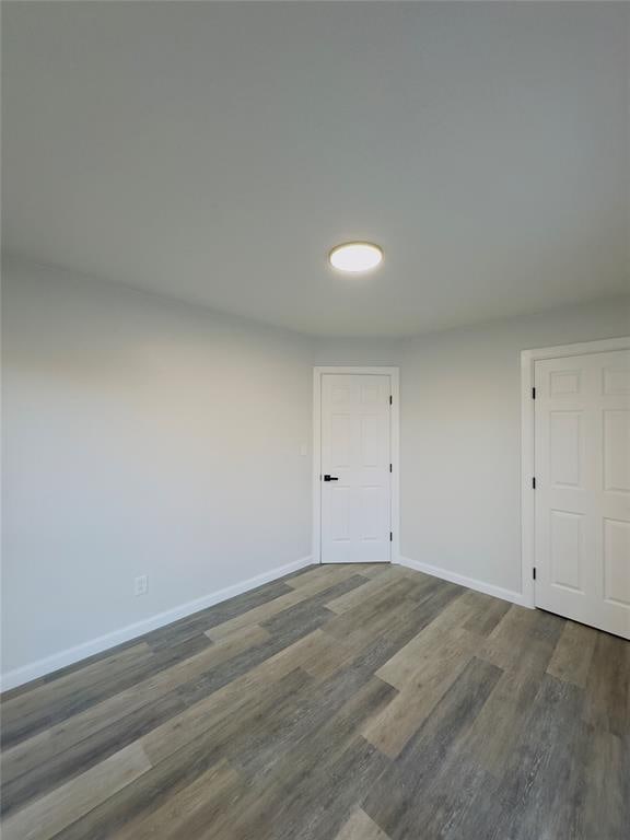 unfurnished room featuring dark hardwood / wood-style flooring