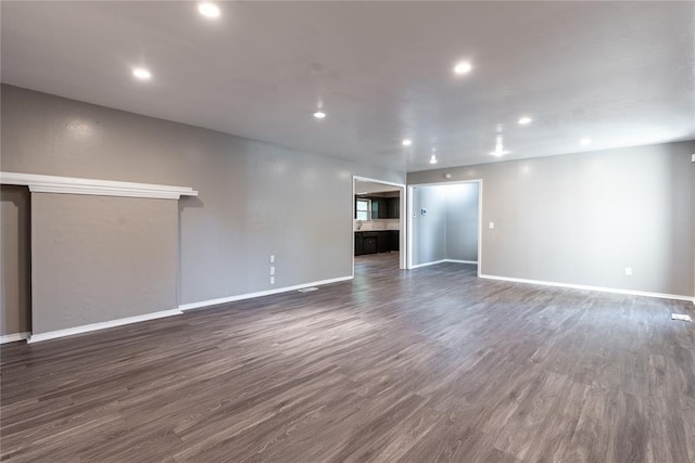 unfurnished living room featuring dark hardwood / wood-style flooring